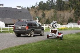 A gray vehicle drives past the radar trailer.
