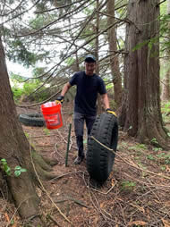 Volunteer moving a Bucket and Tire